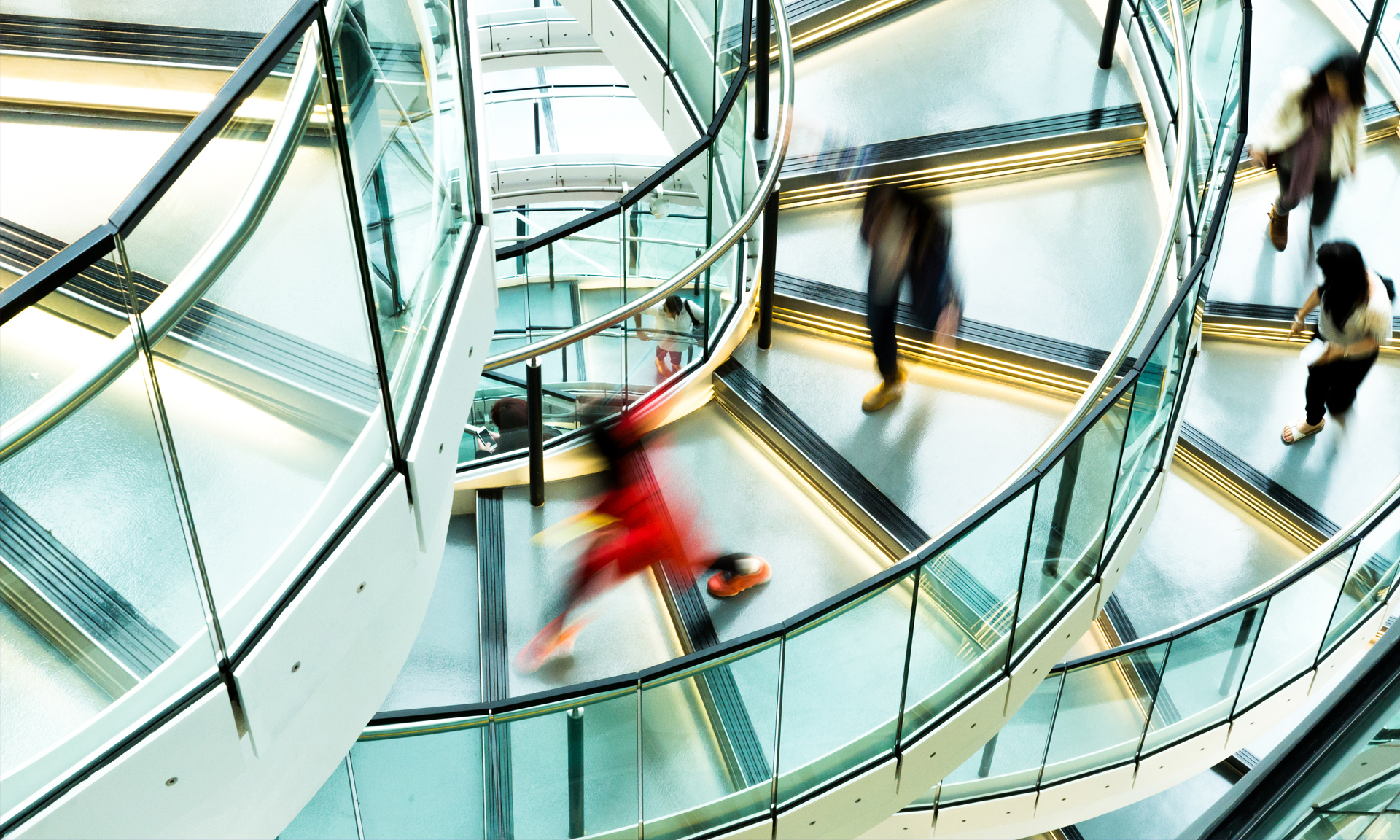 People moving through a modern transit station